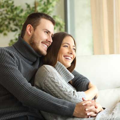 happy couple sitting on couch